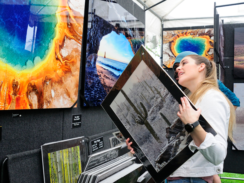 People looking at photographs at the art fair